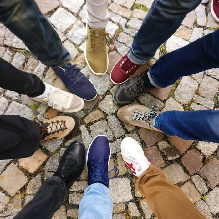 About Circle of sneakers on cobblestone pavement representing diversity and urban fashion.